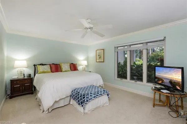a bedroom with a bed and large flat screen tv