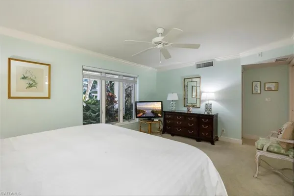 a bedroom with a large bed and dresser
