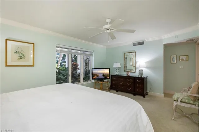 a bedroom with a large bed and dresser