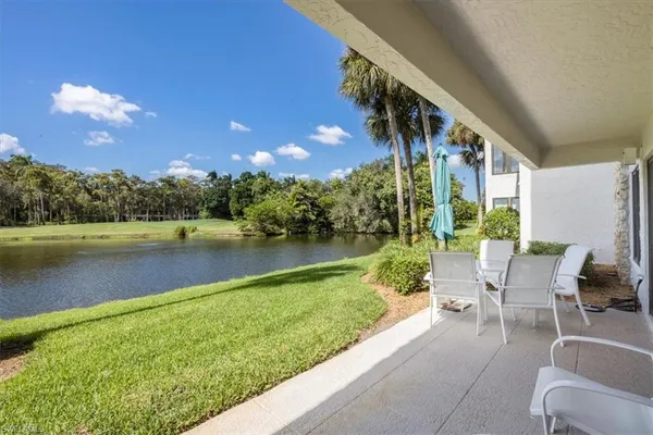 a view of swimming pool with outdoor seating and lake
