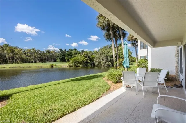 a view of swimming pool with outdoor seating and lake