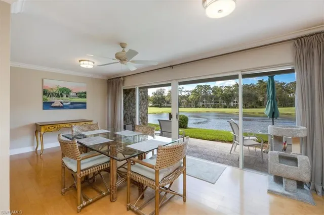a view of a dining room with furniture large windows and wooden floor