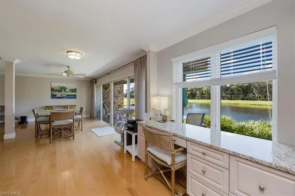 a living room with furniture and a floor to ceiling window