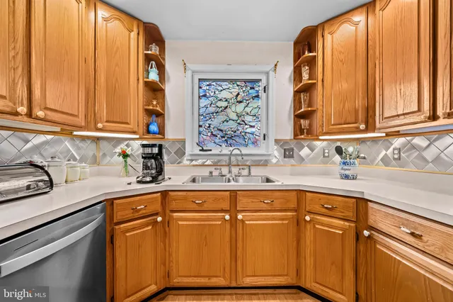 a kitchen with stainless steel appliances granite countertop a sink and cabinets