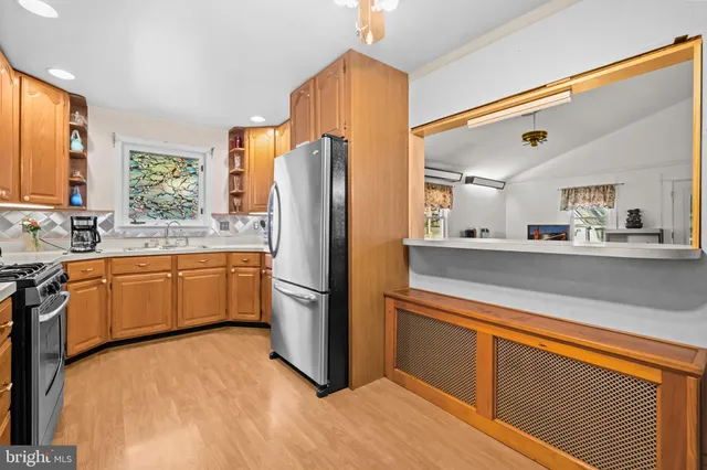 a kitchen with a refrigerator sink and cabinets