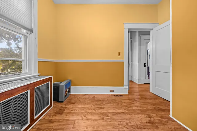 a view of a room with wooden floor