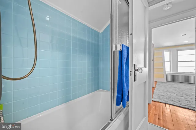 a bathroom with a bathtub and a shower