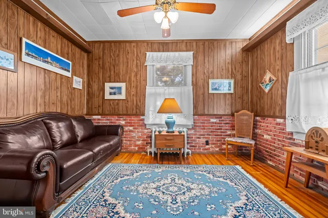 a living room with furniture a rug and a window