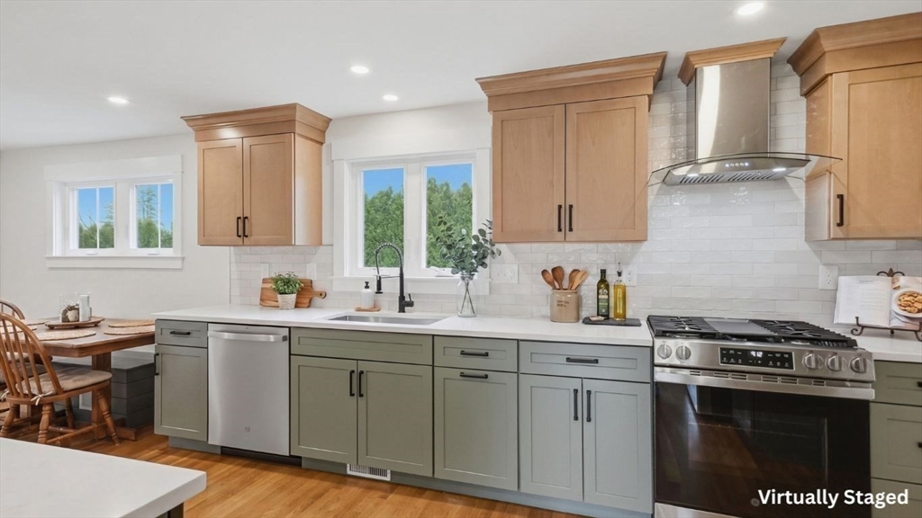 105 Stafford Road Lowell, MA 01852 - Photo 7 of 42 a kitchen with a sink stove and cabinets