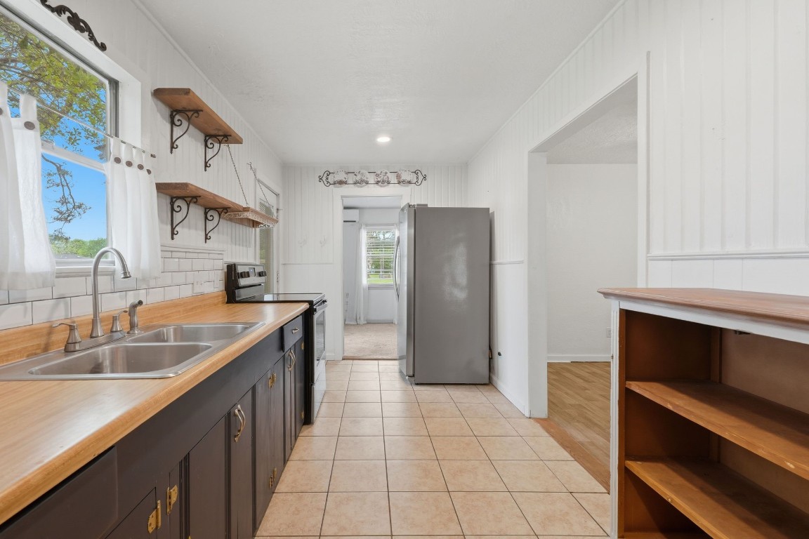 11757 Calvary Road Willis, TX 77318 - Photo 11 of 33 From morning coffee to dinner prep, this kitchen offers great space, open shelving, and a layout that just works.