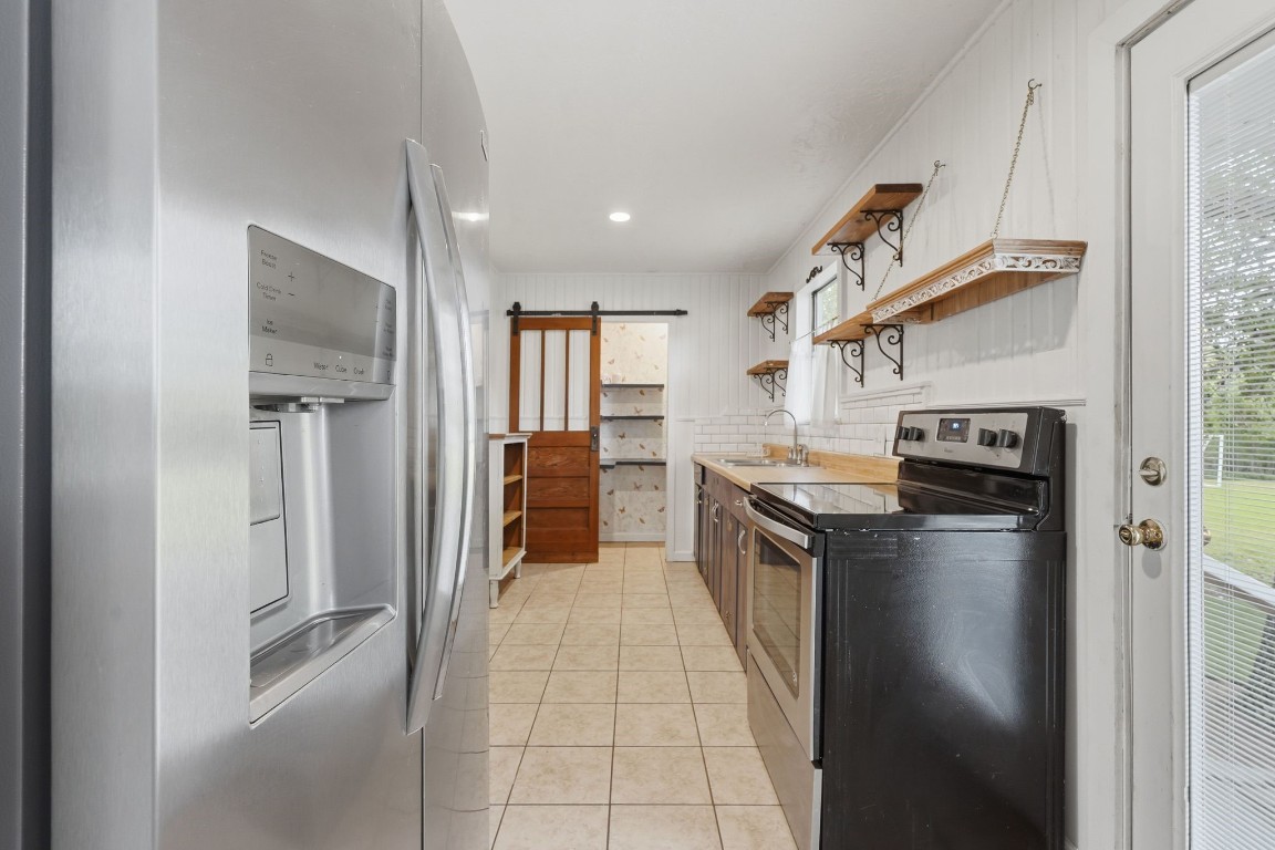 11757 Calvary Road Willis, TX 77318 - Photo 12 of 33 Everything you need is right here, this kitchen features modern appliances, great prep space that keeps things simple and easy.