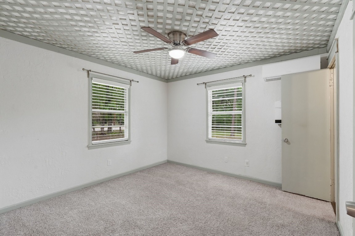 11757 Calvary Road Willis, TX 77318 - Photo 16 of 33 Bright bedroom with two windows bringing in natural light and a comfortable, open feel.