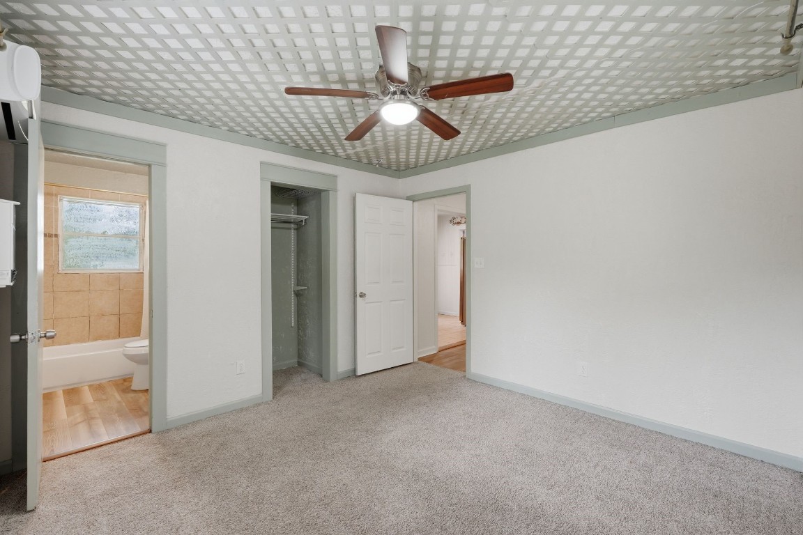 11757 Calvary Road Willis, TX 77318 - Photo 17 of 33 Spacious bedroom with easy access to the bathroom and closet, offering a practical layout.