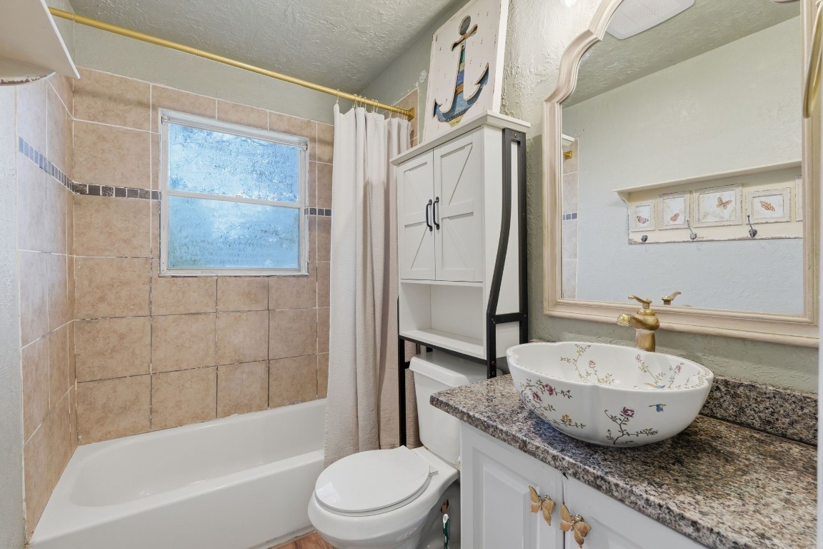 11757 Calvary Road Willis, TX 77318 - Photo 19 of 33 Clean and functional bathroom with a tub and shower combo, plus a nice vanity setup and extra storage.