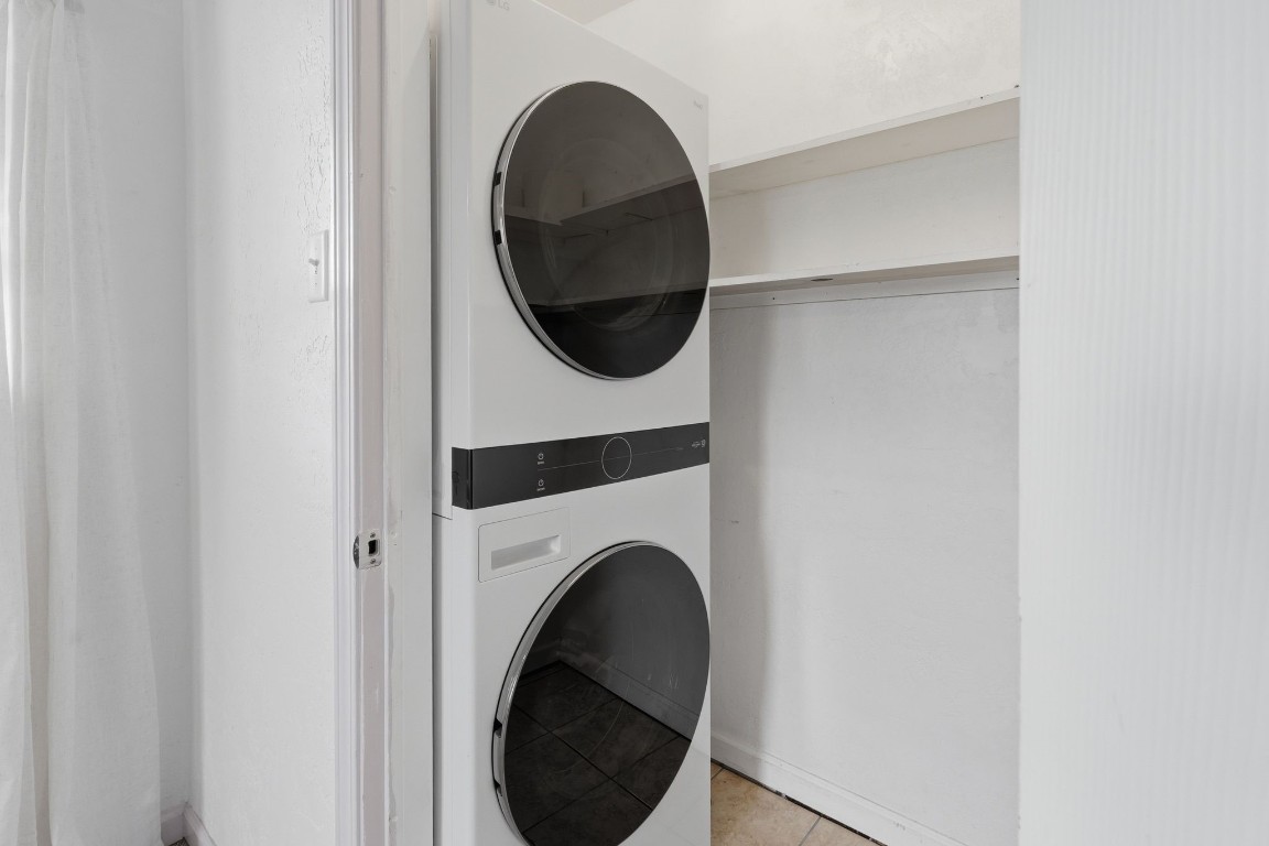 11757 Calvary Road Willis, TX 77318 - Photo 20 of 33 Convenient laundry area with stacked washer and dryer and a little extra space for storage.