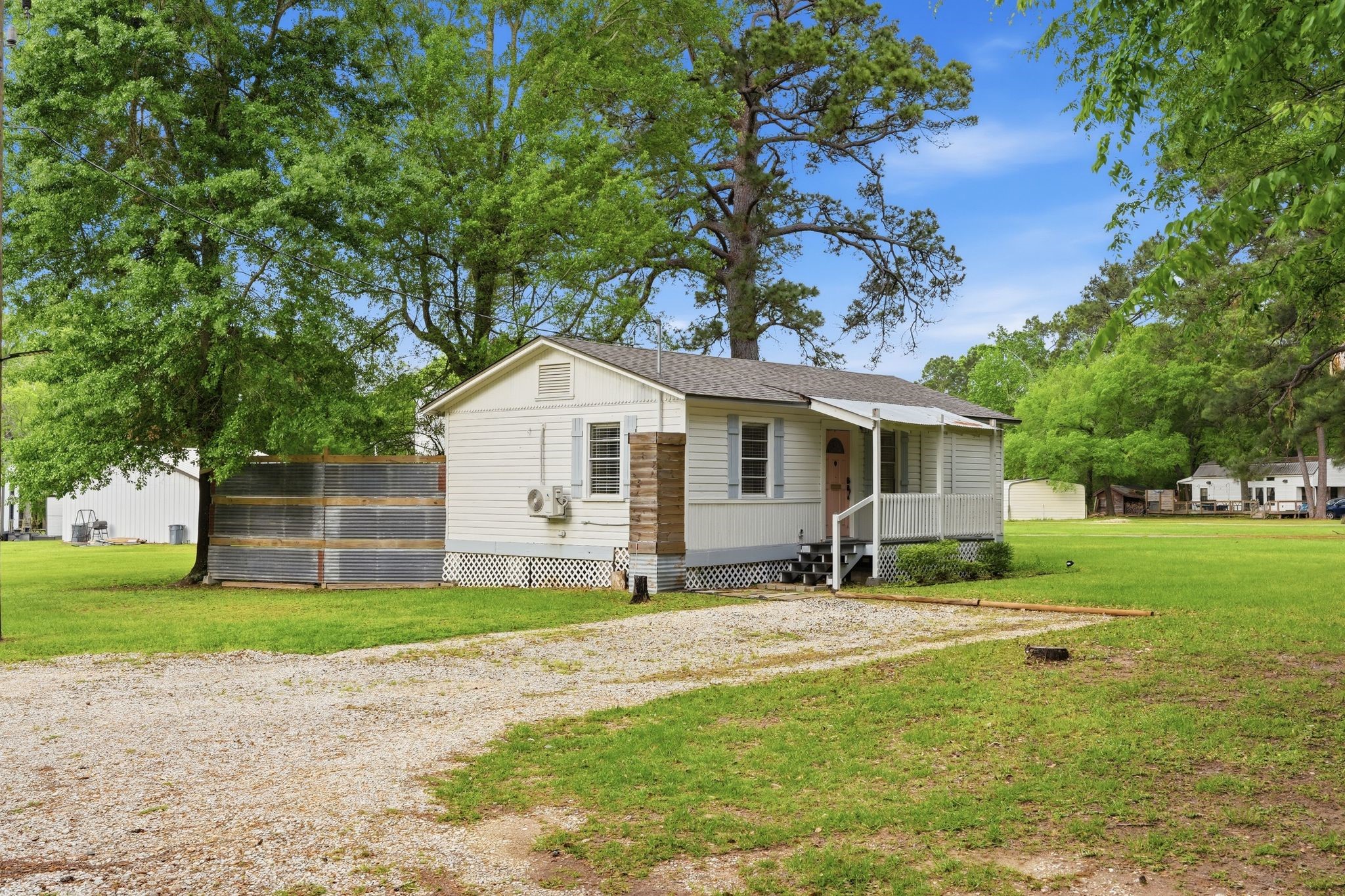 11757 Calvary Road Willis, TX 77318 - Photo 2 of 33 Another look at the home showing the spacious yard and extended driveway. Surrounded by trees, it offers a quiet and relaxed feel.