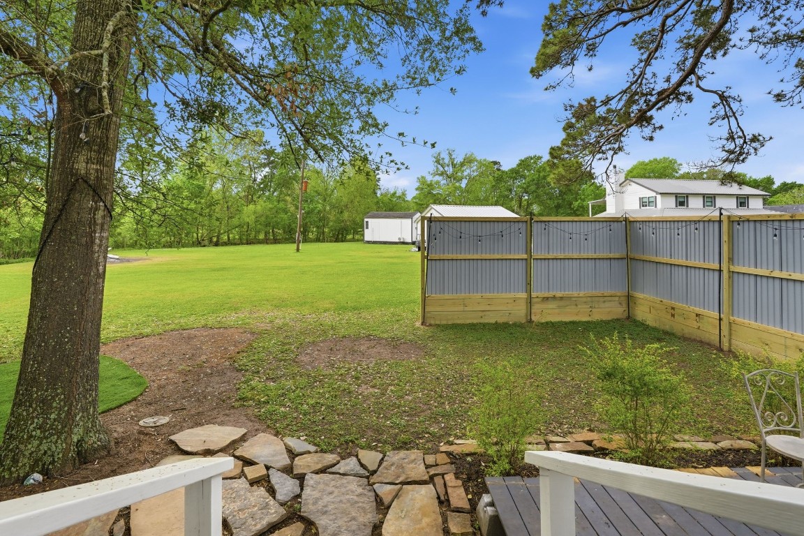 11757 Calvary Road Willis, TX 77318 - Photo 22 of 33 View from the porch looking out to a wide, open yard with plenty of space to enjoy the outdoors.