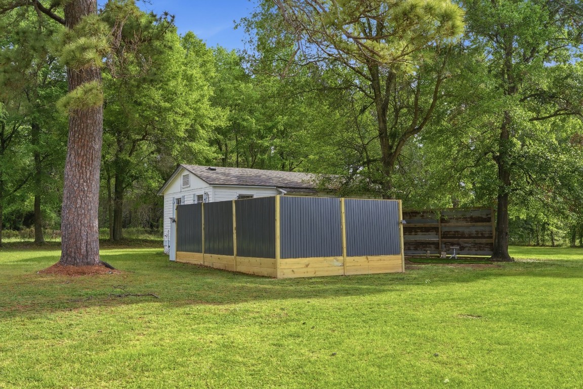 11757 Calvary Road Willis, TX 77318 - Photo 25 of 33 Spacious yard with a fenced area, offering added privacy and plenty of room to enjoy outdoor living.