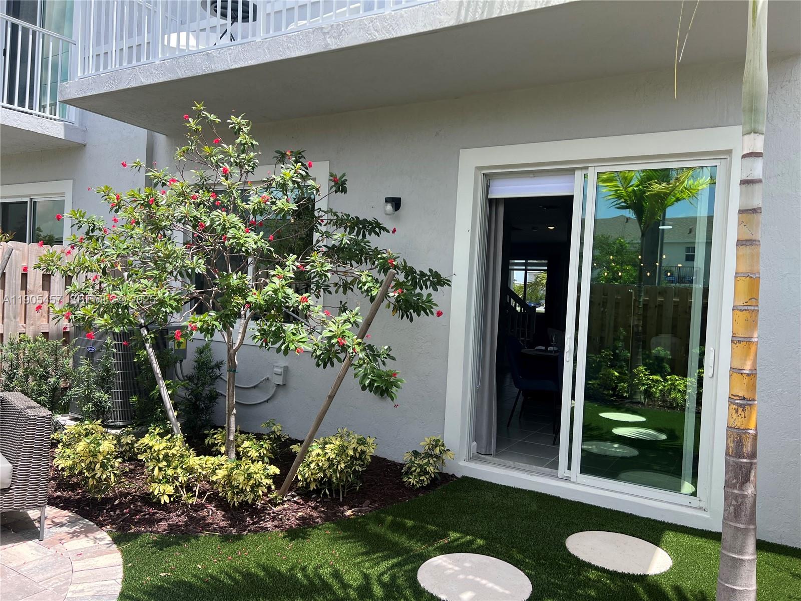 640 Southeast 14th Street Homestead, FL 33034 - Photo 16 of 29 a view of a chair and table in a garden