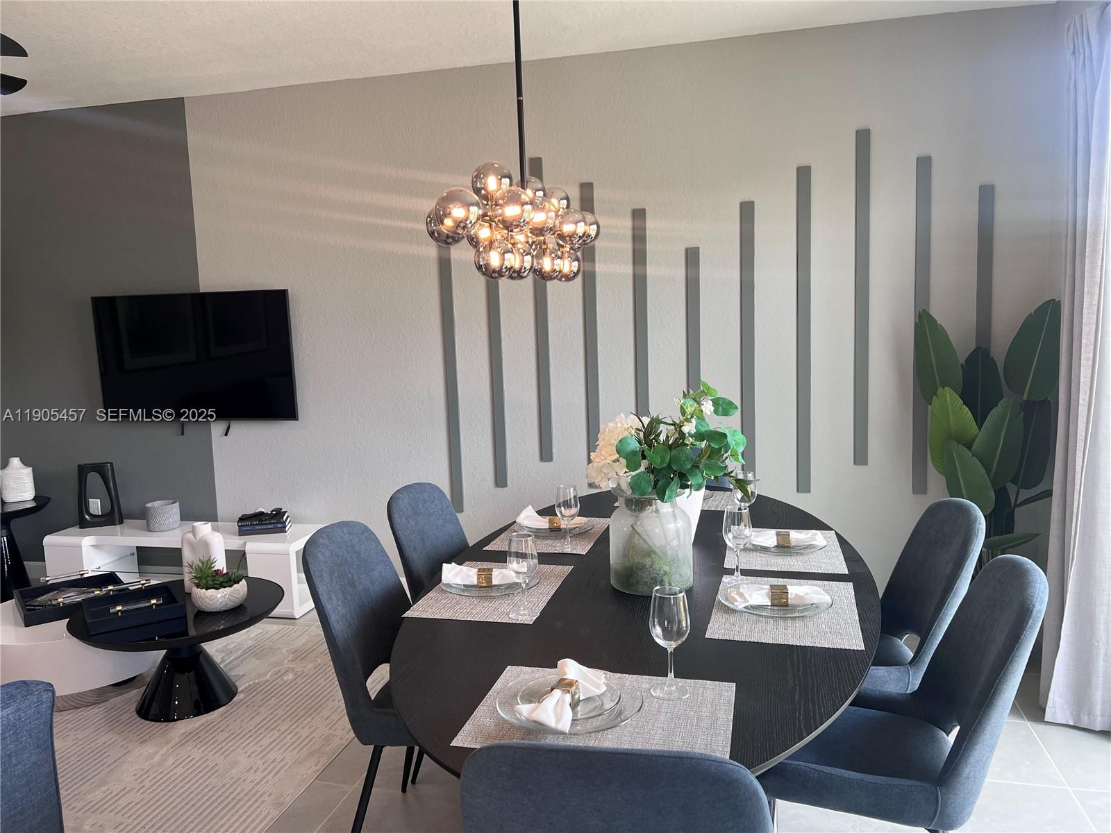 640 Southeast 14th Street Homestead, FL 33034 - Photo 3 of 29 a view of a livingroom with furniture a flat screen tv and a potted plant