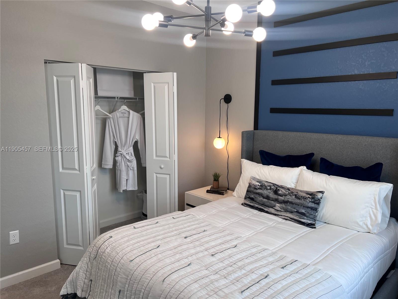 640 Southeast 14th Street Homestead, FL 33034 - Photo 6 of 29 a bedroom with a bed and a chandelier