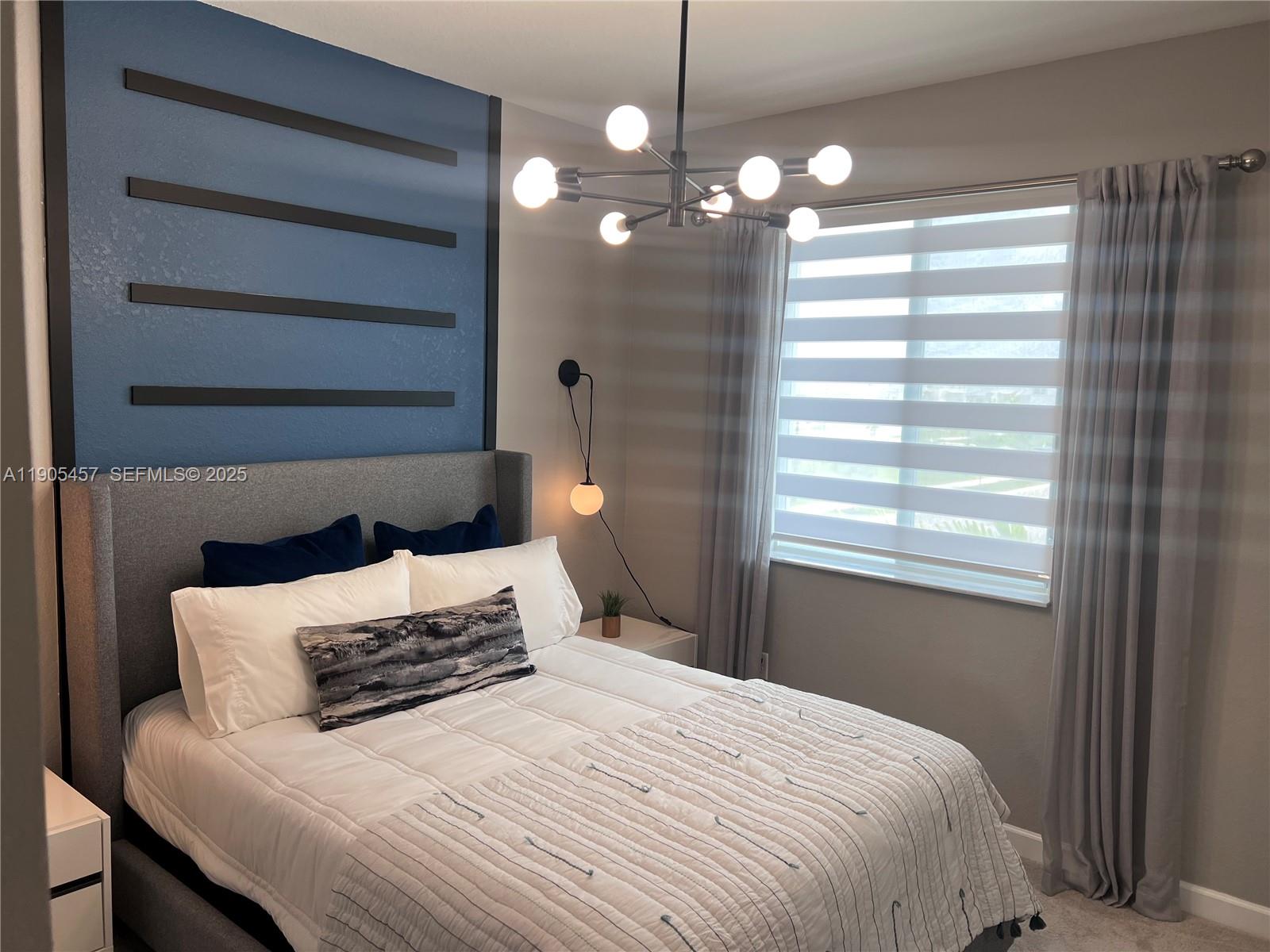 640 Southeast 14th Street Homestead, FL 33034 - Photo 7 of 29 a bedroom with a bed and a window