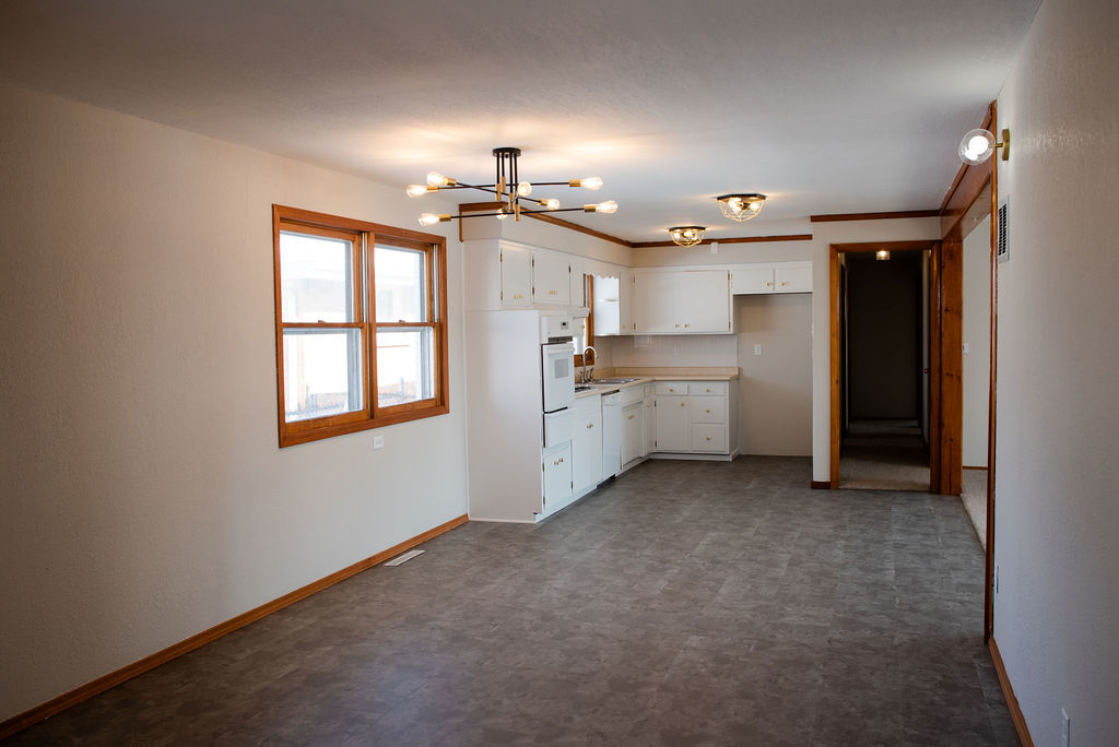 425 West Donald Street Kankakee, IL 60901 - Photo 5 of 14 a view of a kitchen with a sink and dishwasher a refrigerator with wooden floor