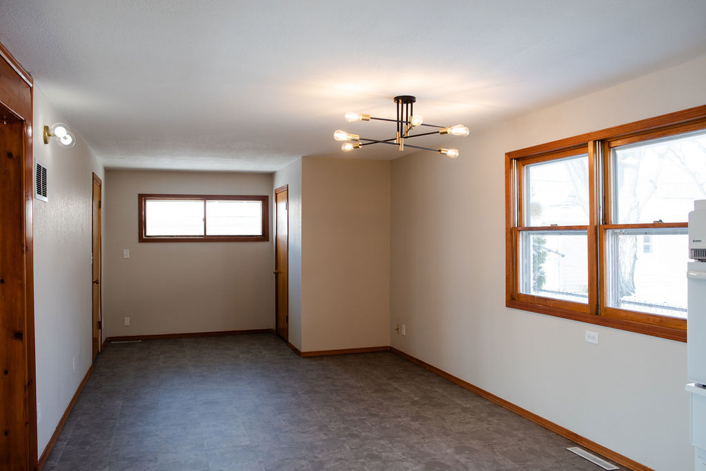 425 West Donald Street Kankakee, IL 60901 - Photo 7 of 14 an empty room with chandelier fan and windows