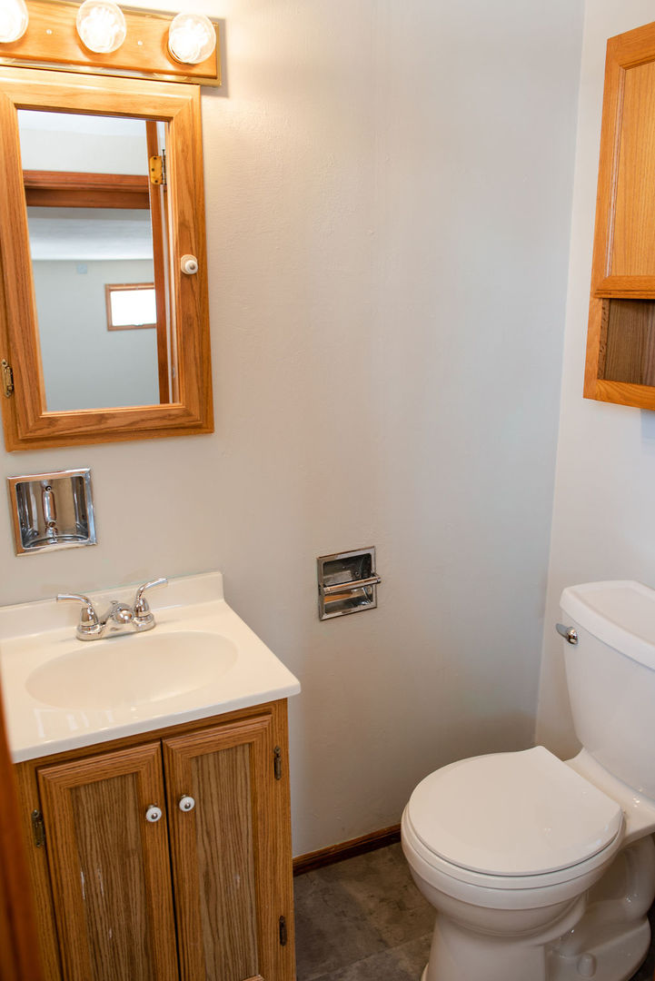 425 West Donald Street Kankakee, IL 60901 - Photo 9 of 14 a bathroom with a sink a toilet and mirror