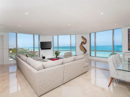 a living room with furniture tv and a large window