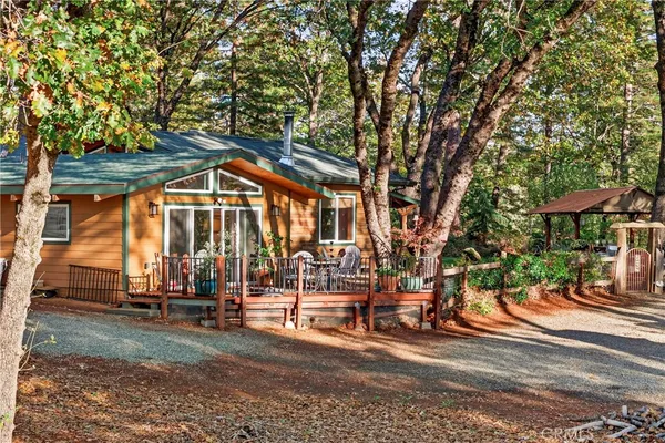 a backyard of a house with barbeque oven table and chairs