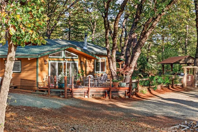 a backyard of a house with barbeque oven table and chairs