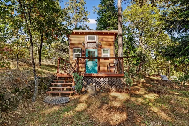 a view of a chair and tables in the patio in front of house