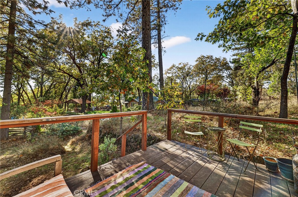 15001 Culiacan Court Forest Ranch, CA 95942 - Photo 36 of 66 a view of a balcony with wooden floor and bench