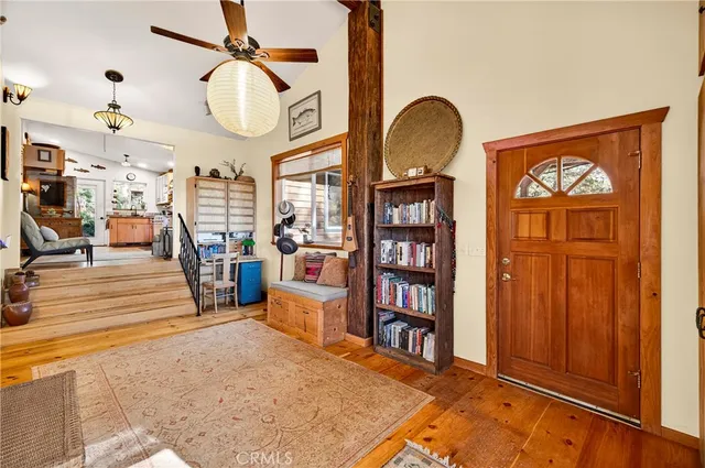 a living room with furniture a flat screen tv and a floor to ceiling window