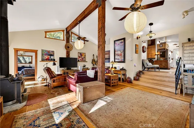 a living room with fireplace furniture and a window