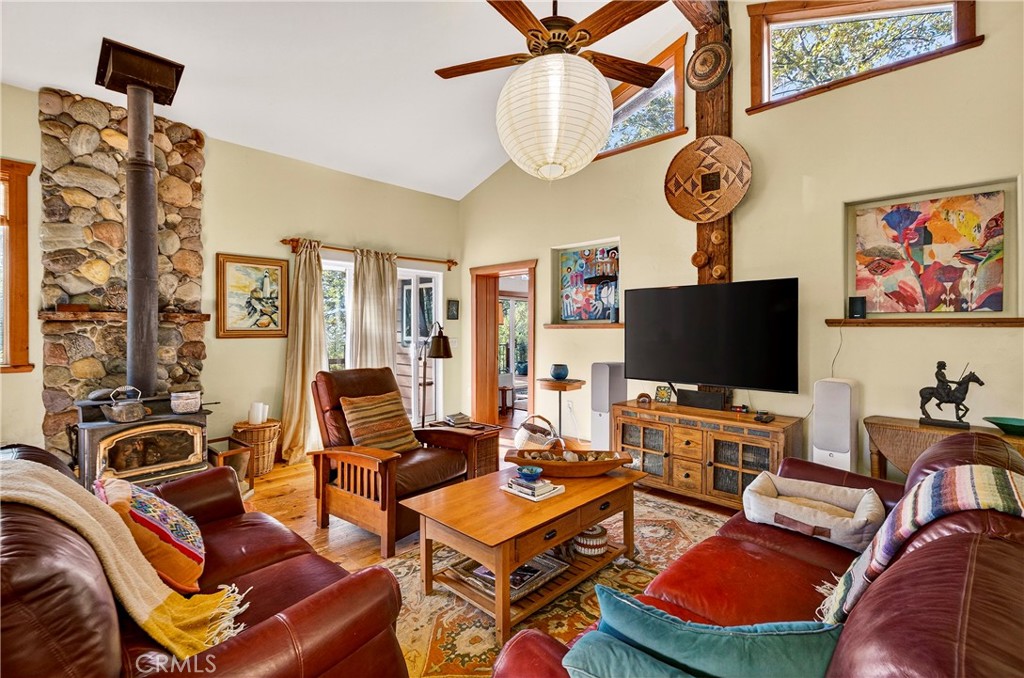 15001 Culiacan Court Forest Ranch, CA 95942 - Photo 7 of 66 a living room with furniture a flat screen tv and a floor to ceiling window