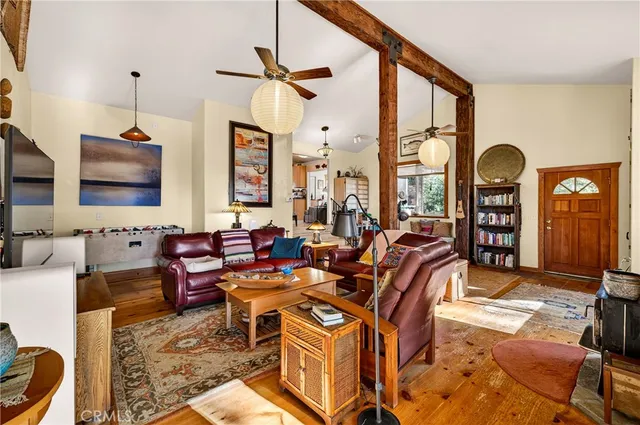 a kitchen with stainless steel appliances granite countertop a refrigerator a sink dishwasher a stove and white countertops with wooden floor