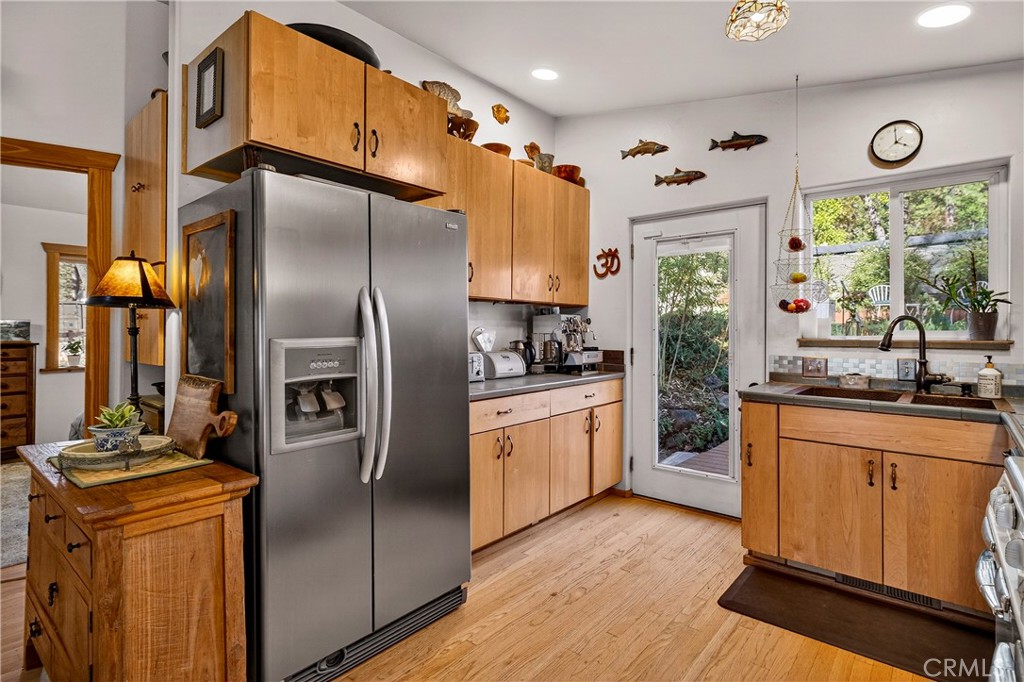 15001 Culiacan Court Forest Ranch, CA 95942 - Photo 10 of 66 a kitchen with stainless steel appliances granite countertop a refrigerator a sink dishwasher a stove and white countertops with wooden floor