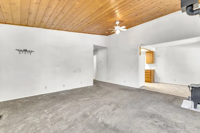 a bathroom with a granite countertop sink mirror vanity and a bathtub