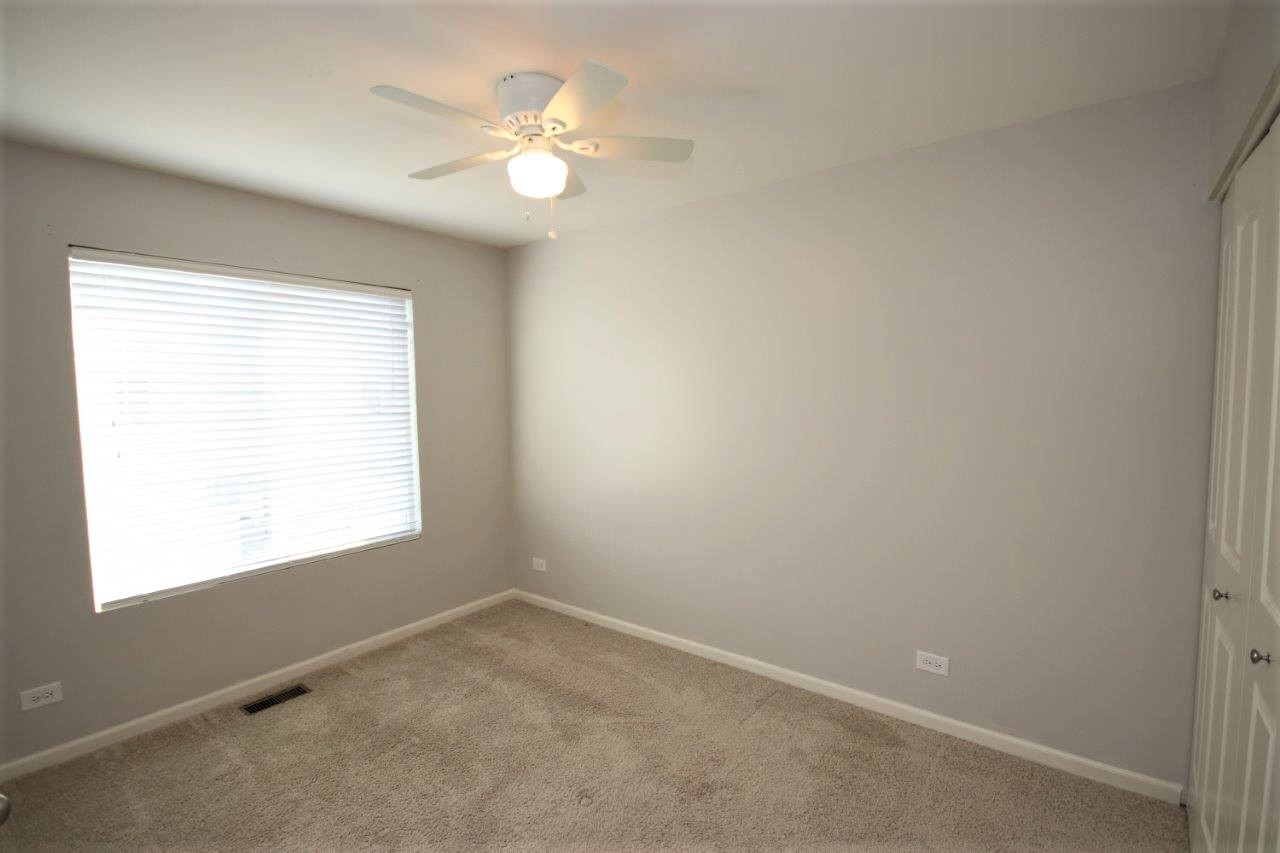1785 Ruby Drive Pingree Grove, IL 60140 - Photo 13 of 24 an empty room with windows and fan