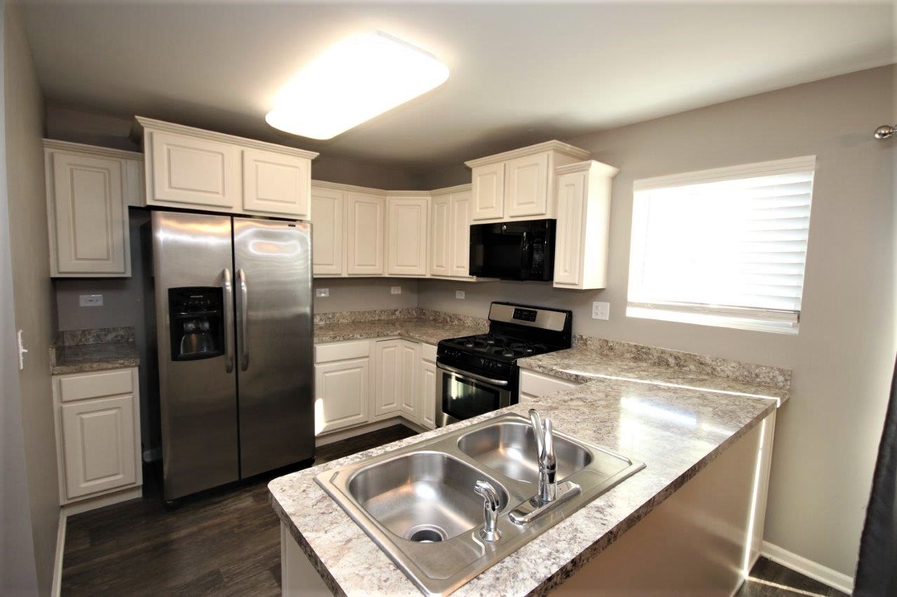 1785 Ruby Drive Pingree Grove, IL 60140 - Photo 4 of 24 a kitchen with stainless steel appliances granite countertop a sink a stove and a refrigerator