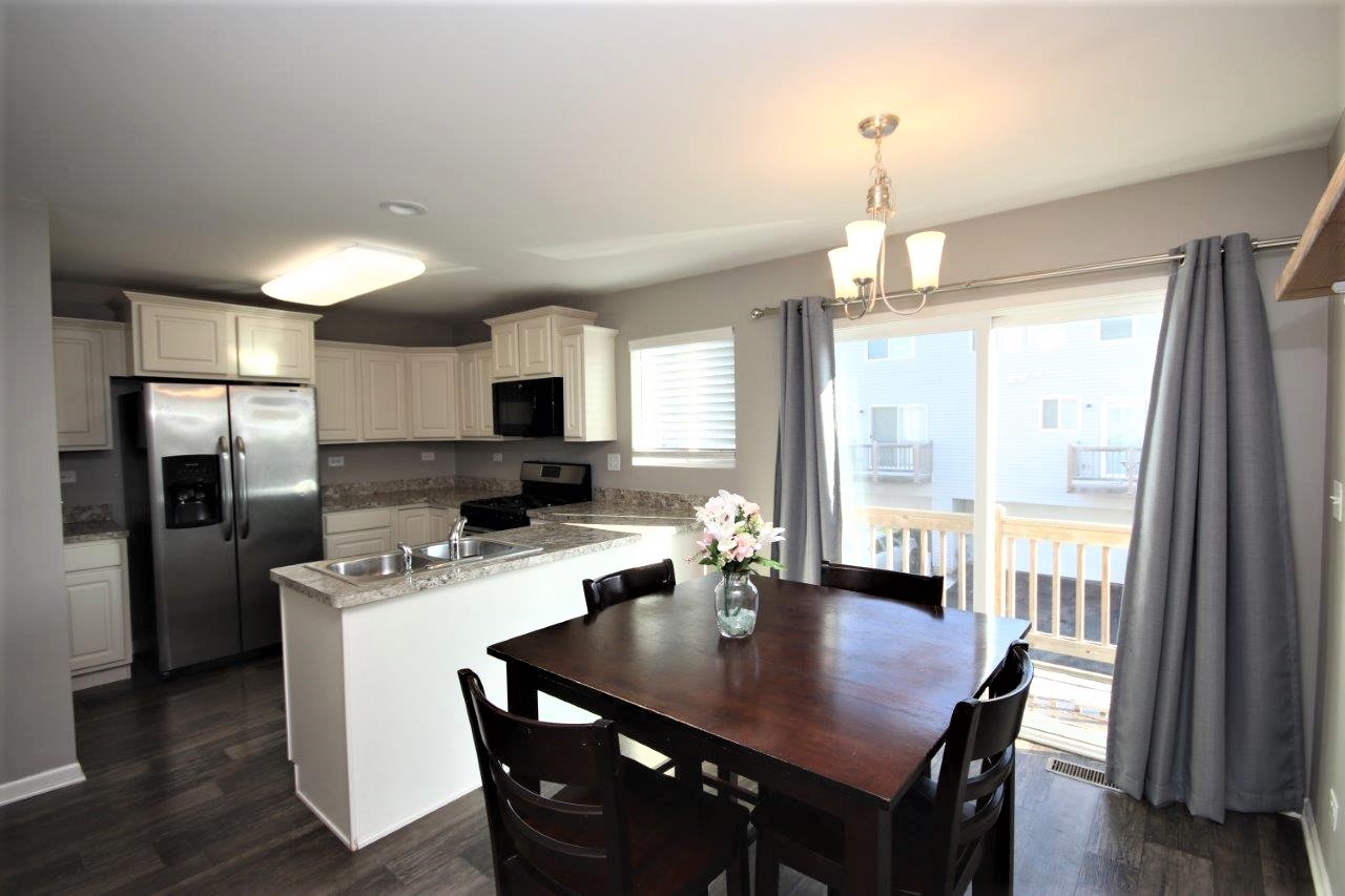 1785 Ruby Drive Pingree Grove, IL 60140 - Photo 5 of 24 a kitchen with a dining table and chairs
