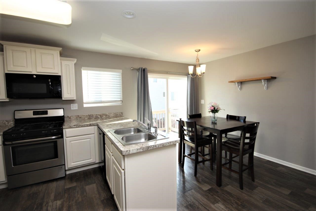 1785 Ruby Drive Pingree Grove, IL 60140 - Photo 6 of 24 a kitchen with a stove a sink and a refrigerator