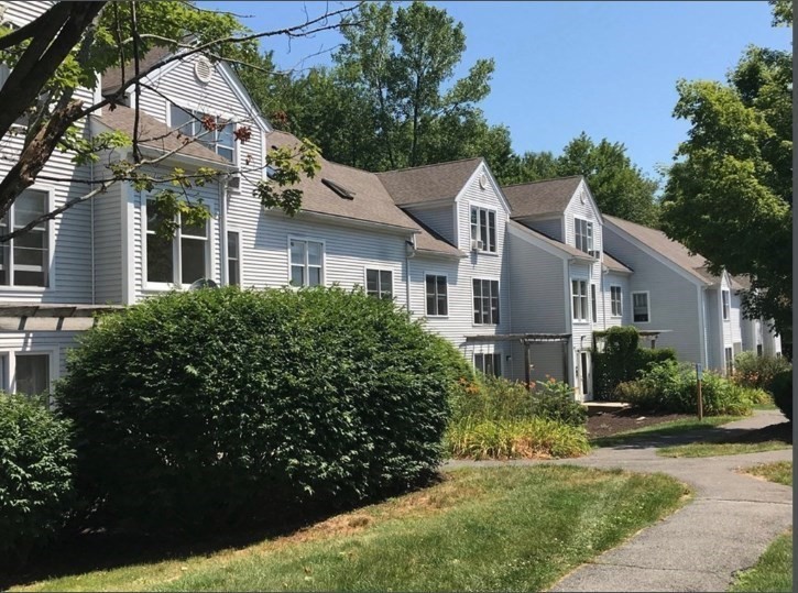 34 Salem Place, Unit 34 Amherst, MA 01002 - Photo 1 of 8 a view of a white house with a big yard and potted plants
