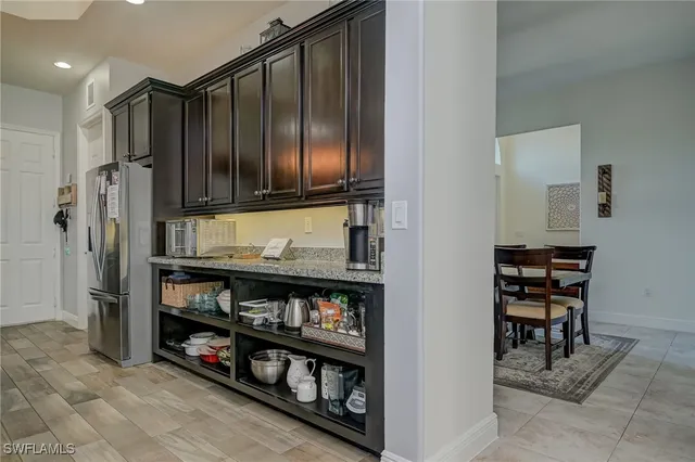 a kitchen with stainless steel appliances granite countertop a refrigerator and a stove
