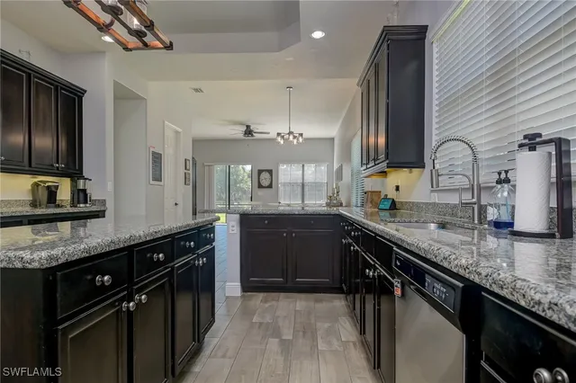 a kitchen with stainless steel appliances granite countertop counter space a sink and cabinets