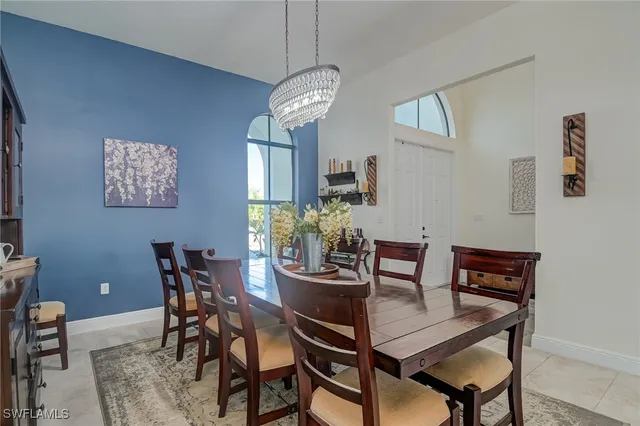 a view of a dining room with furniture and a chandelier