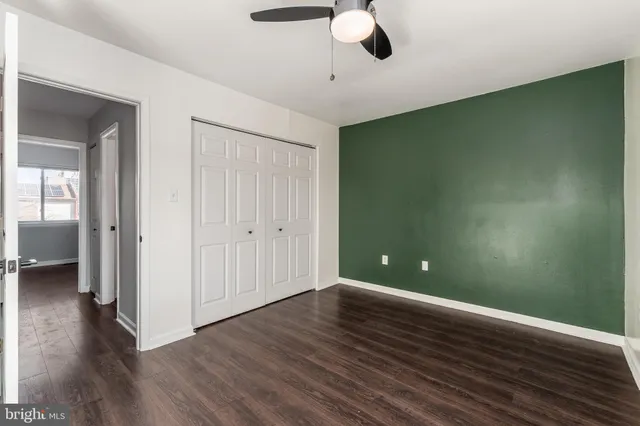 a view of wooden floor and an entryway in a room
