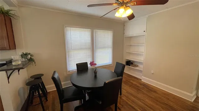 a view of a dining room with furniture and a potted plant